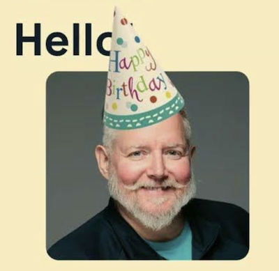 Martin smiling and wearing a "Happy Birthday" hat.